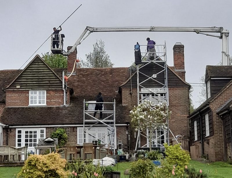 The Roof Moss Cleaners using cherry picker and scaffolding to clean roof safely and professionally in Northampton, Northamptonshire
